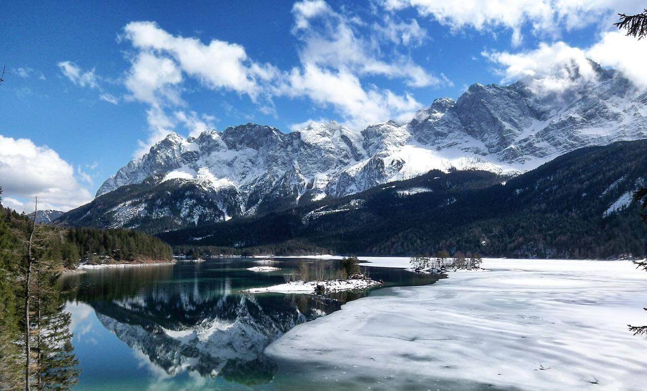 Snow-covered mountains reflected in a pristine lake